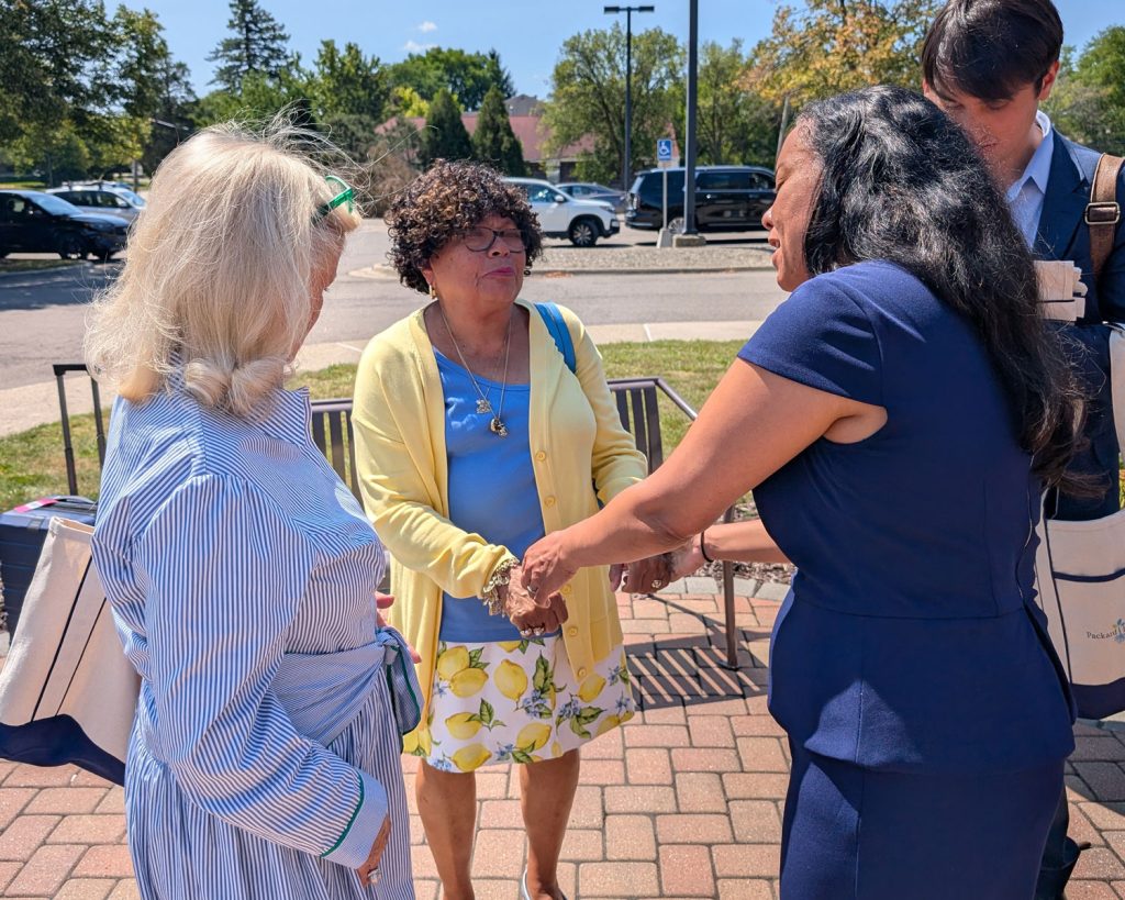 Representatives Dingell and Mejia speaking with Packard Health board member and patient